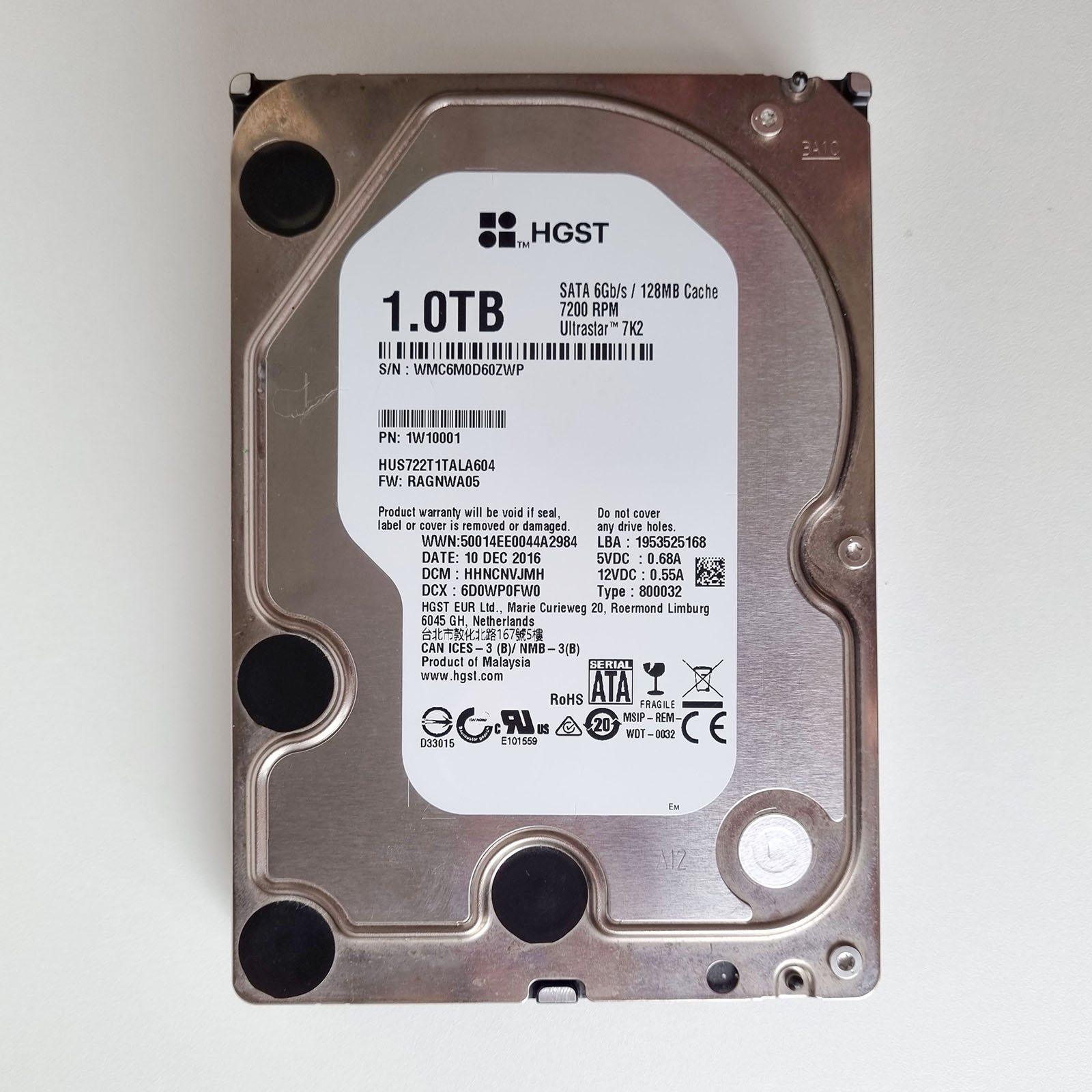 Label side of a 1TB HGST Ultrastar 7K2 hard drive, showing its SATA interface, 7200 RPM rating, and model number.