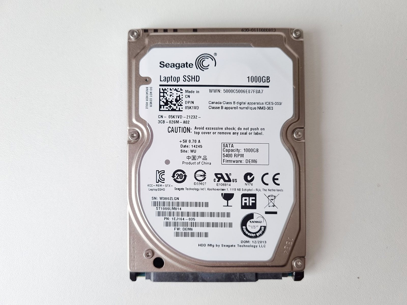 Label side of a Seagate 1TB laptop SSHD, showing its SATA interface and 5400 RPM rating.